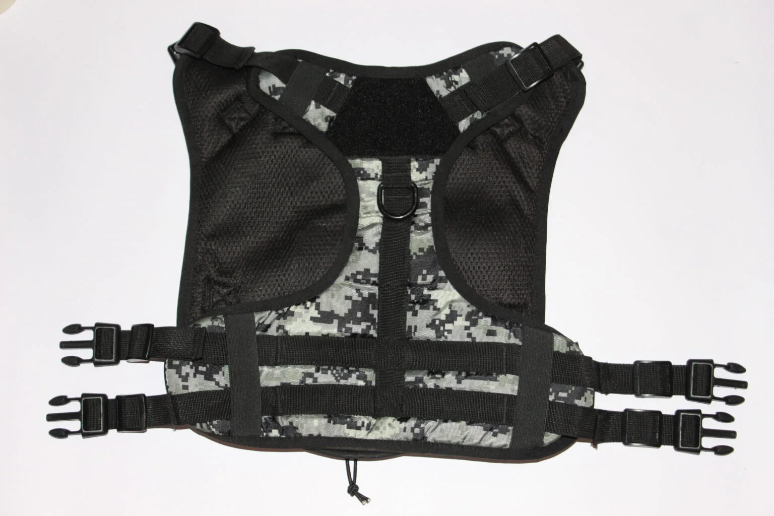 Flat view of a heavy-duty camouflage tactical pet harness with secure quick-release buckles and adjustable straps from The Woof Parade.