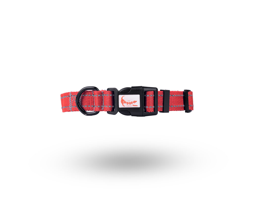Durable red reflective dog collar with a secure side press buckle and metal D-ring by The Woof Parade.